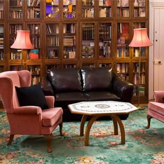 The Club Room seating with bookshelf lined wall.