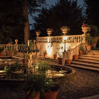 The fountain and garden illuminated at night.
