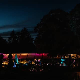 Wedding marquee illuminated at night.