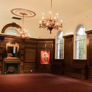 The main space at St. Botolph’s Church Hall with oak panels and chandeliers.